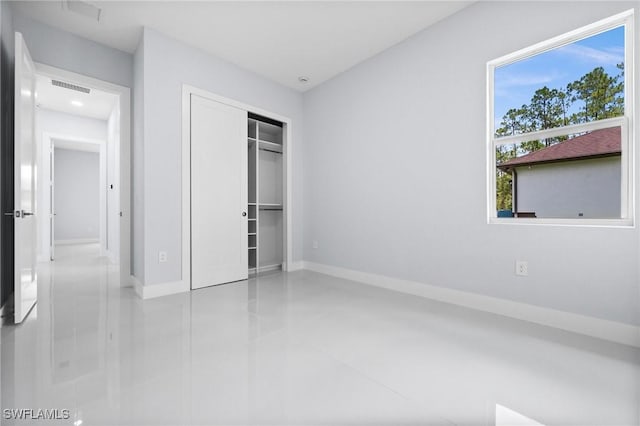 3990 27th Ave NE, Naples, FL 34120 - unfurnished bedroom featuring a closet and tile patterned flooring