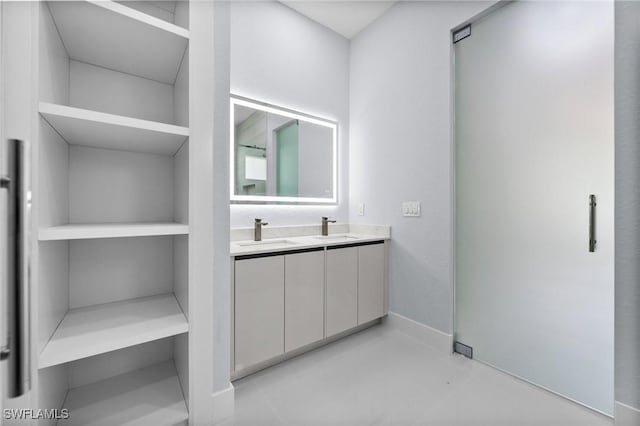 3990 27th Ave NE, Naples, FL 34120 - bathroom featuring double vanity and baseboards
