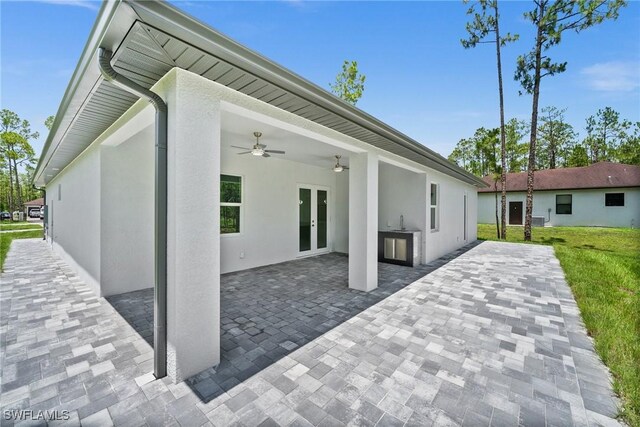 3990 27th Ave NE, Naples, FL 34120 - back of house with french doors, ceiling fan, stucco siding, and a patio area