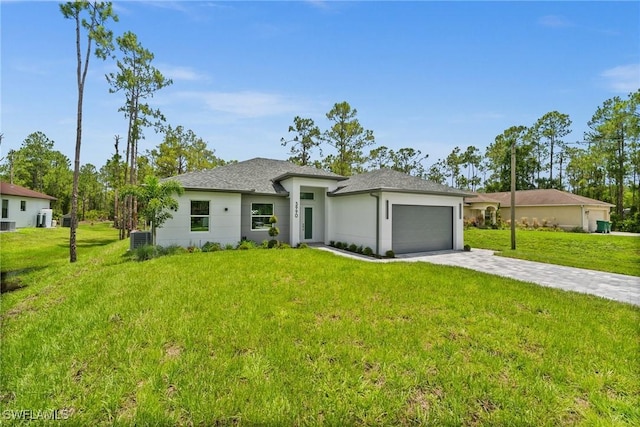 3990 27th Ave NE, Naples, FL 34120 - view of front facade with a garage, driveway, a front lawn, and a shingled roof