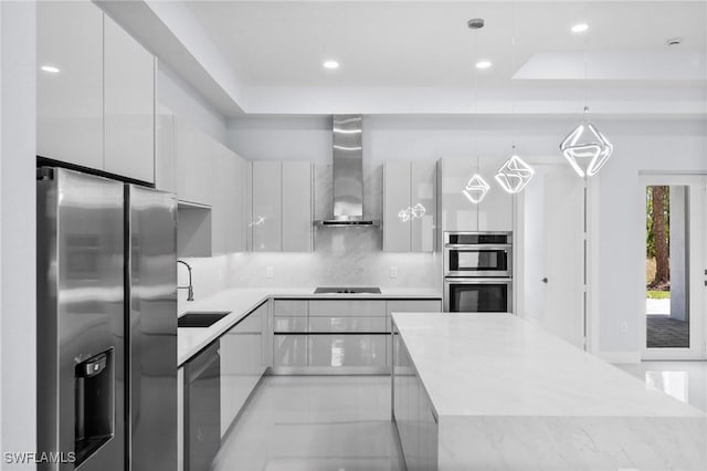 3990 27th Ave NE, Naples, FL 34120 - kitchen featuring stainless steel appliances, wall chimney exhaust hood, modern cabinets, white cabinets, and tasteful backsplash