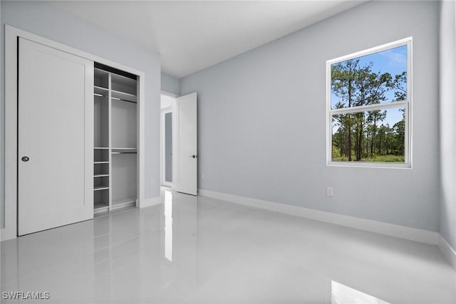 3990 27th Ave NE, Naples, FL 34120 - unfurnished bedroom featuring a closet and baseboards