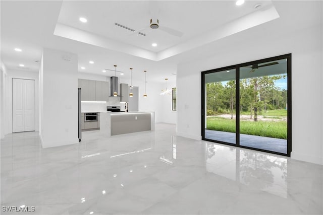1018 Calvin Ave, Lehigh Acres, FL 33972 - unfurnished living room with a raised ceiling, recessed lighting, light marble finish floors, and ceiling fan
