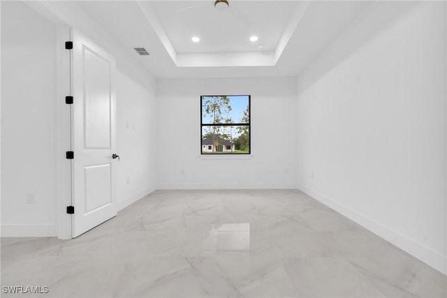 1018 Calvin Ave, Lehigh Acres, FL 33972 - spare room with light marble finish floors, recessed lighting, and a tray ceiling