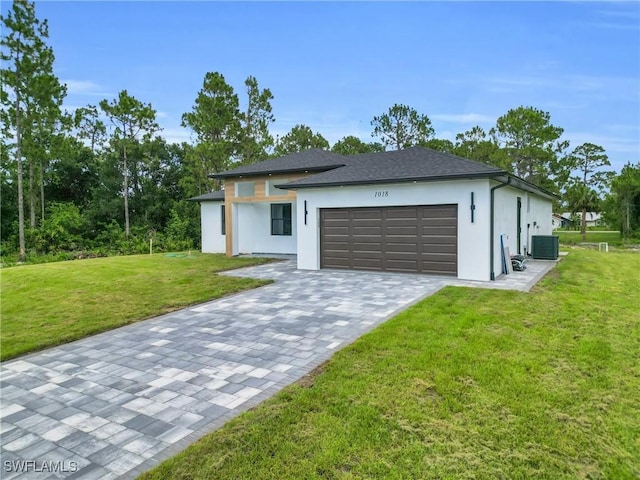 1018 Calvin Ave, Lehigh Acres, FL 33972 - view of front of home featuring stucco siding, a garage, a front yard, and decorative driveway