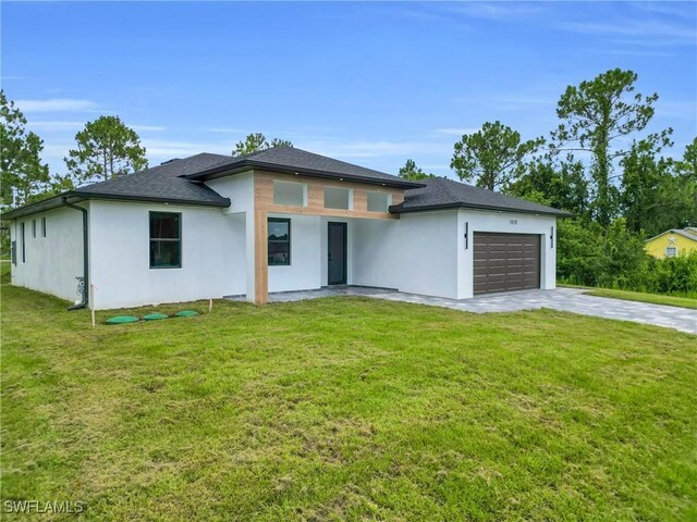 1018 Calvin Ave, Lehigh Acres, FL 33972 - prairie-style home featuring stucco siding, a garage, concrete driveway, and a front lawn