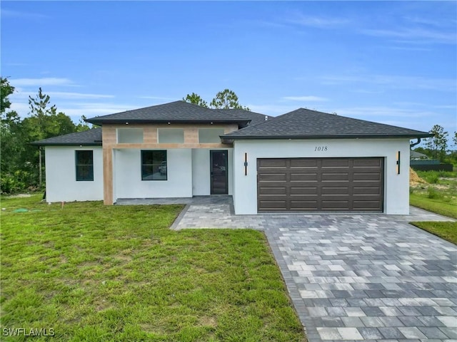 1018 Calvin Ave, Lehigh Acres, FL 33972 - prairie-style home featuring stucco siding, an attached garage, and a front lawn