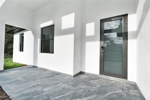 1018 Calvin Ave, Lehigh Acres, FL 33972 - property entrance featuring stucco siding and a patio