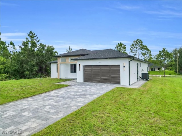 1018 Calvin Ave, Lehigh Acres, FL 33972 - view of front of home with an attached garage, stucco siding, a front lawn, and decorative driveway