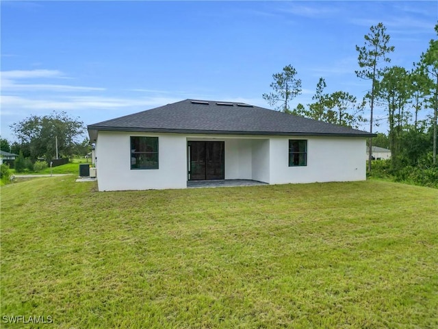 1018 Calvin Ave, Lehigh Acres, FL 33972 - rear view of property with stucco siding, a lawn, and roof with shingles