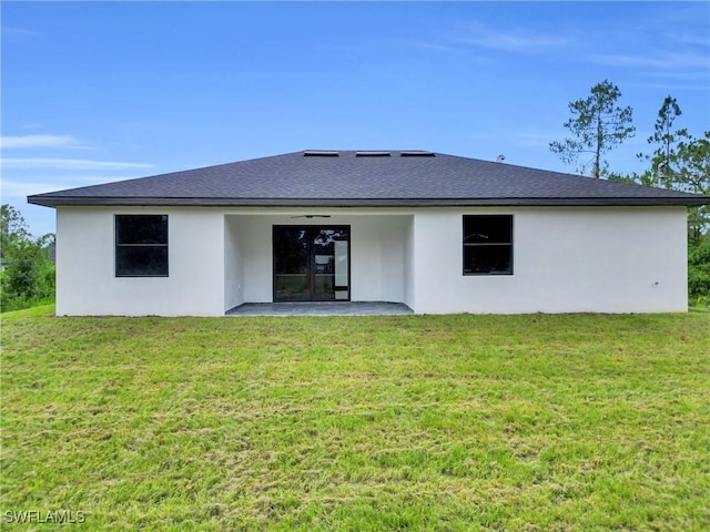1018 Calvin Ave, Lehigh Acres, FL 33972 - back of property with ceiling fan, a patio, stucco siding, and a yard