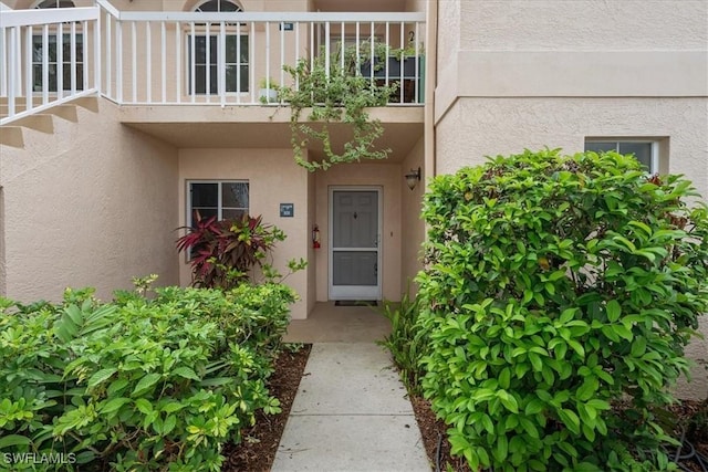 2810 Citrus Lake Dr Unit U101, Naples, FL 34109 - doorway to property featuring stucco siding and a balcony