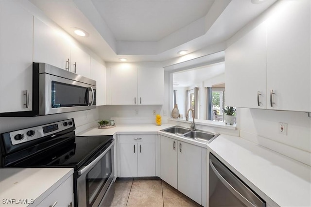 2810 Citrus Lake Dr Unit U101, Naples, FL 34109 - kitchen featuring appliances with stainless steel finishes, white cabinets, light countertops, light tile patterned floors, and recessed lighting