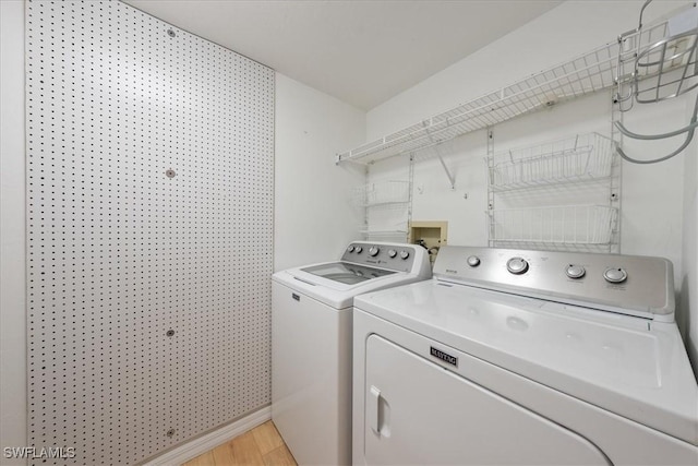 2810 Citrus Lake Dr Unit U101, Naples, FL 34109 - laundry room featuring washing machine and dryer and light wood-style floors