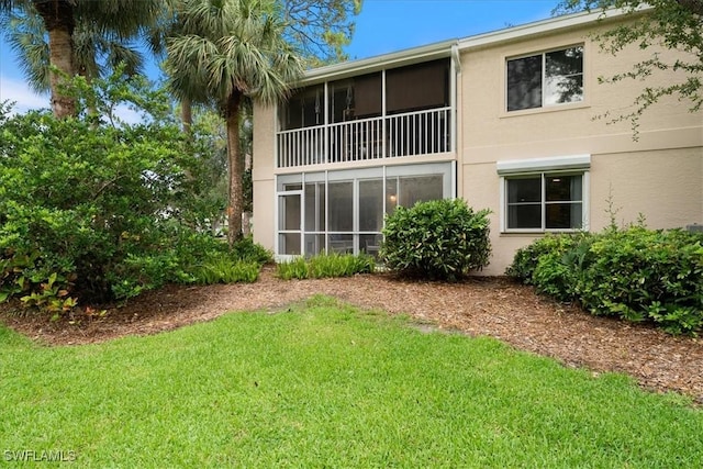 2810 Citrus Lake Dr Unit U101, Naples, FL 34109 - back of house featuring a lawn and stucco siding