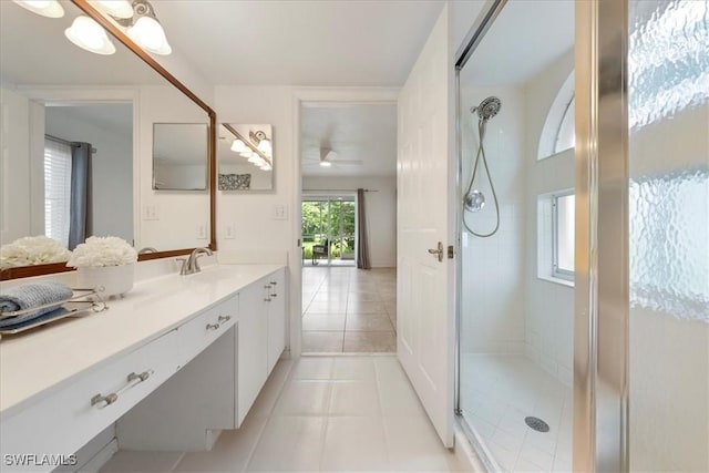 2810 Citrus Lake Dr Unit U101, Naples, FL 34109 - bathroom with a tile shower, vanity, tile patterned flooring, and ceiling fan