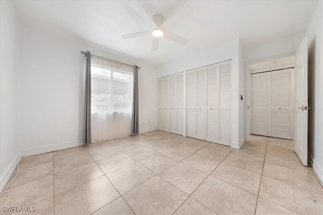 2810 Citrus Lake Dr Unit U101, Naples, FL 34109 - unfurnished bedroom with light tile patterned floors and ceiling fan