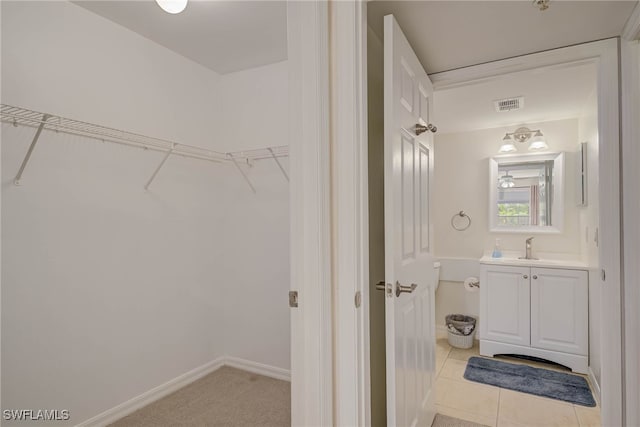 1763 Four Mile Cove Pkwy Unit 611, Cape Coral, FL 33990 - bathroom featuring vanity, a spacious closet, and tile patterned floors