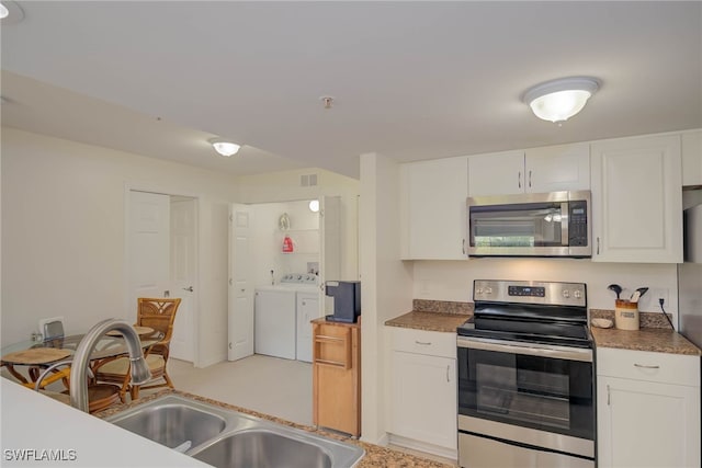 1763 Four Mile Cove Pkwy Unit 611, Cape Coral, FL 33990 - kitchen with stainless steel appliances, separate washer and dryer, white cabinets, and dark countertops