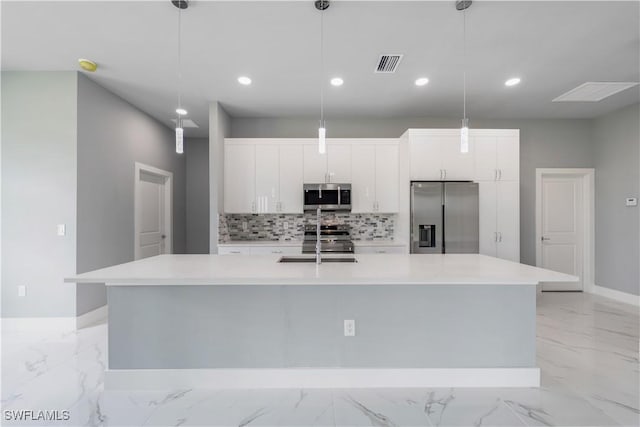 4002 22nd St SW, Lehigh Acres, FL 33976 - kitchen featuring stainless steel appliances, light marble finish floors, a large island with sink, backsplash, and white cabinets