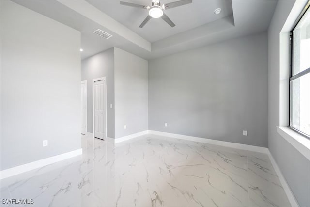 4002 22nd St SW, Lehigh Acres, FL 33976 - empty room featuring a ceiling fan, light marble finish flooring, a tray ceiling, and recessed lighting