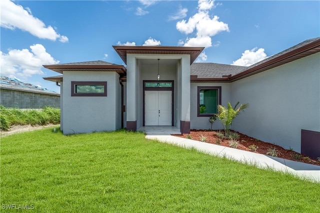 4002 22nd St SW, Lehigh Acres, FL 33976 - property entrance with stucco siding, a yard, and roof with shingles
