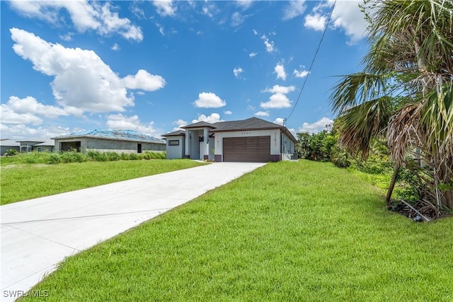 4002 22nd St SW, Lehigh Acres, FL 33976 - view of front facade with a front yard, driveway, and a garage