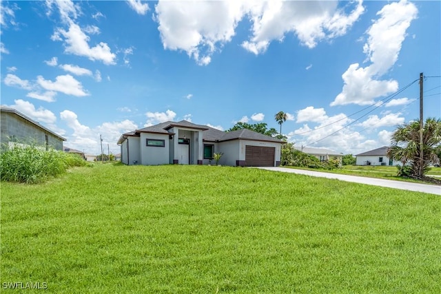 4002 22nd St SW, Lehigh Acres, FL 33976 - prairie-style house with concrete driveway, a garage, stucco siding, and a front yard