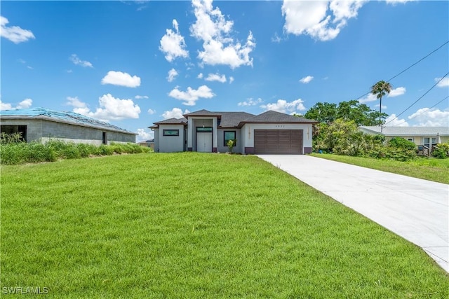 4002 22nd St SW, Lehigh Acres, FL 33976 - prairie-style home with an attached garage, a front yard, driveway, and stucco siding