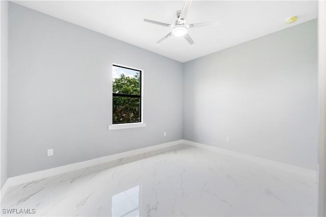 4002 22nd St SW, Lehigh Acres, FL 33976 - empty room with marble look tiles and a ceiling fan
