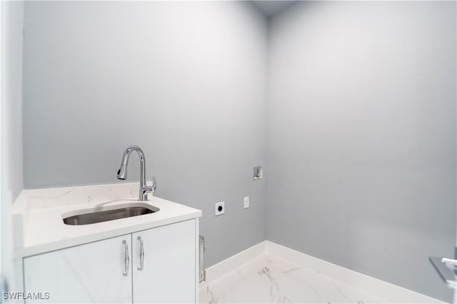 4002 22nd St SW, Lehigh Acres, FL 33976 - washroom featuring hookup for an electric dryer, cabinet space, and marble finish flooring