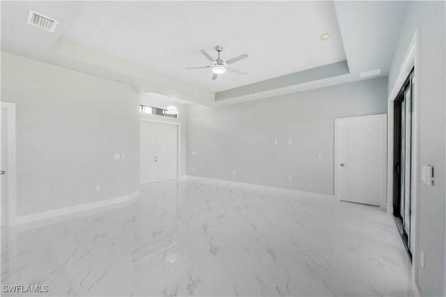 4002 22nd St SW, Lehigh Acres, FL 33976 - unfurnished room featuring a raised ceiling, ceiling fan, and light marble finish floors
