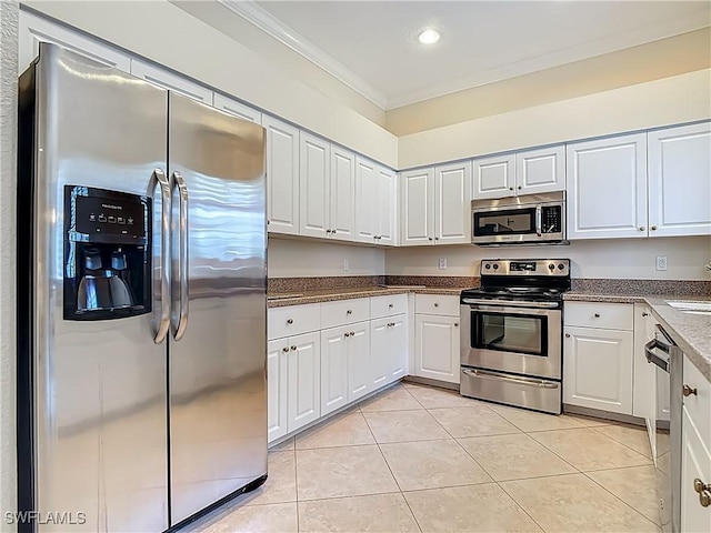 2050 Rio Nuevo Dr, North Fort Myers, FL 33917 - kitchen featuring stainless steel appliances, light tile patterned floors, ornamental molding, white cabinetry, and recessed lighting