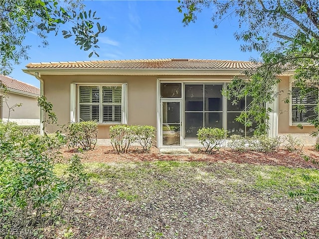 2050 Rio Nuevo Dr, North Fort Myers, FL 33917 - back of house featuring stucco siding and a tile roof