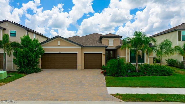 3470 Nombella Ct, Fort Myers, FL 33905 - view of front of home with stucco siding, a garage, decorative driveway, and a front yard