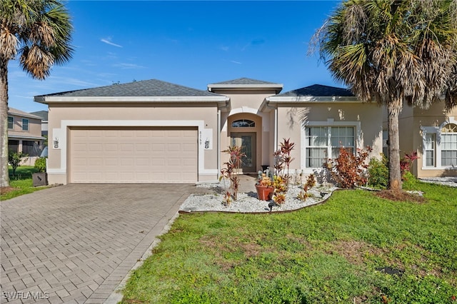 8169 Silver Birch Way, Lehigh Acres, FL 33971 - ranch-style home featuring stucco siding, a garage, driveway, and a front lawn