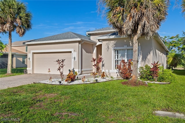 8169 Silver Birch Way, Lehigh Acres, FL 33971 - ranch-style house with stucco siding, a garage, driveway, and a front yard