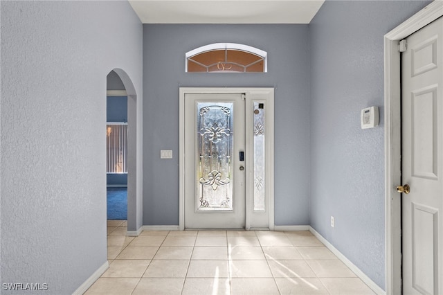 8169 Silver Birch Way, Lehigh Acres, FL 33971 - tiled foyer entrance featuring a textured wall and arched walkways