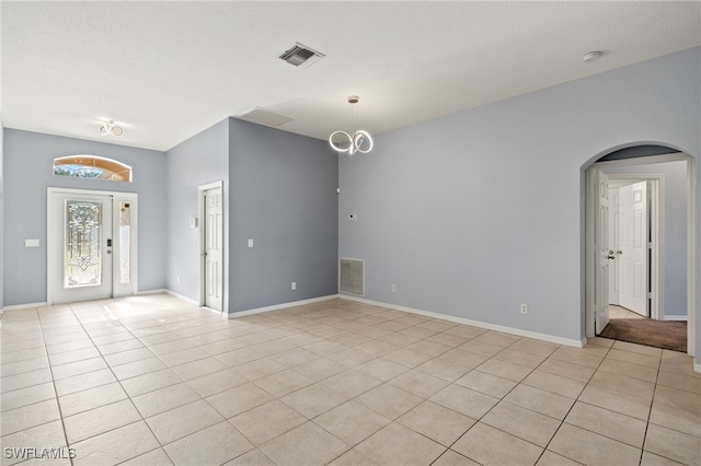 8169 Silver Birch Way, Lehigh Acres, FL 33971 - spare room with arched walkways, light tile patterned flooring, and a smoke detector