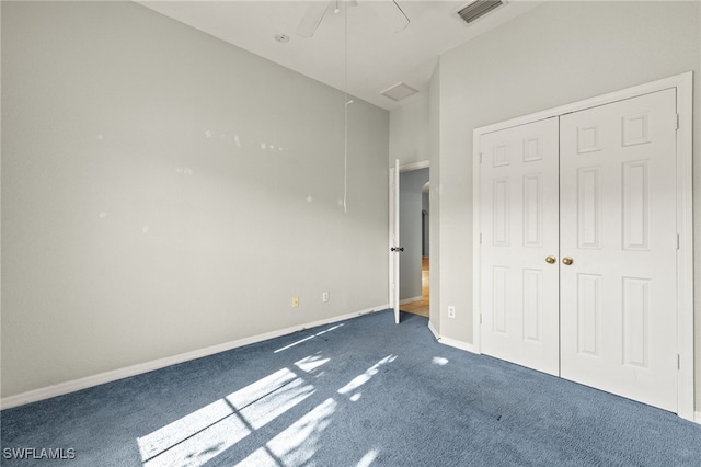 8169 Silver Birch Way, Lehigh Acres, FL 33971 - unfurnished bedroom featuring dark carpet, a closet, and a ceiling fan