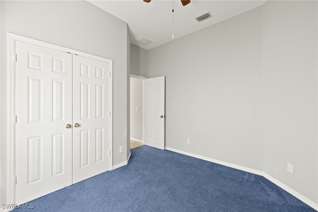 8169 Silver Birch Way, Lehigh Acres, FL 33971 - unfurnished bedroom with dark colored carpet, a closet, and a ceiling fan