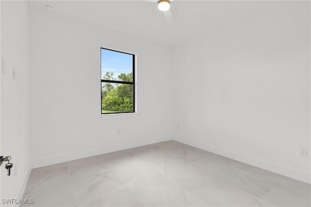1018 Clayton Ave, Lehigh Acres, FL 33972 - spare room featuring light marble finish flooring and baseboards