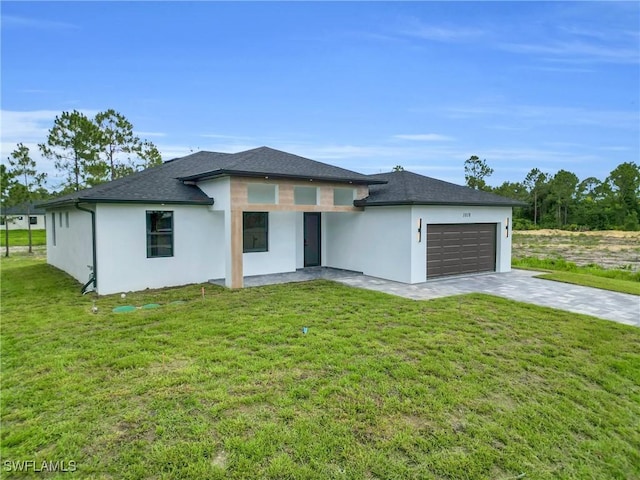 1018 Clayton Ave, Lehigh Acres, FL 33972 - prairie-style house with a garage, concrete driveway, stucco siding, and a front yard