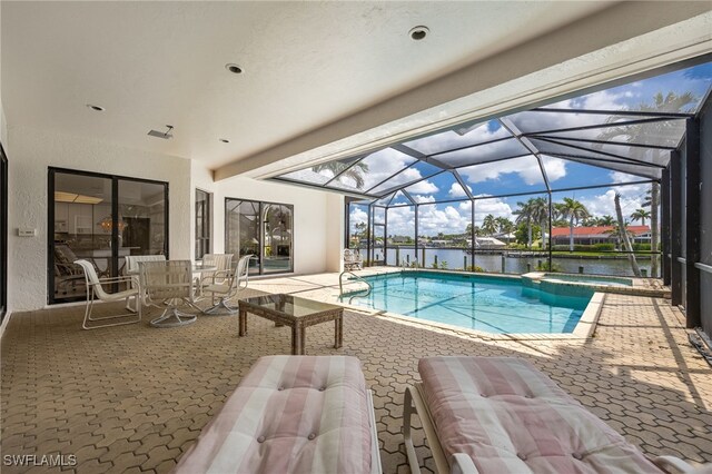 1167 SW 57th St, Cape Coral, FL 33914 - view of swimming pool with a patio area, a water view, a pool with connected hot tub, and glass enclosure