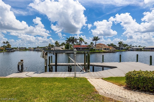 1167 SW 57th St, Cape Coral, FL 33914 - dock area featuring a water view, a yard, boat lift, and a residential view