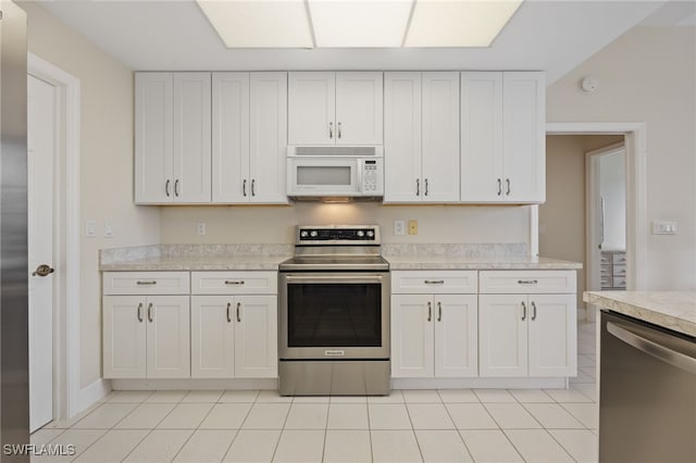 1167 SW 57th St, Cape Coral, FL 33914 - kitchen featuring stainless steel appliances, light tile patterned flooring, light countertops, and white cabinets