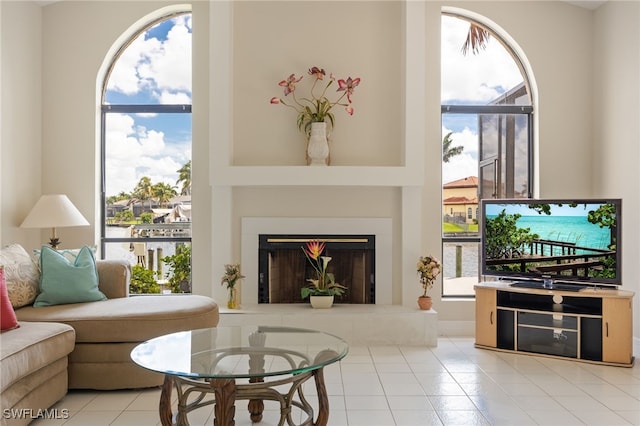 1167 SW 57th St, Cape Coral, FL 33914 - living room featuring tile patterned flooring, plenty of natural light, and a fireplace with raised hearth