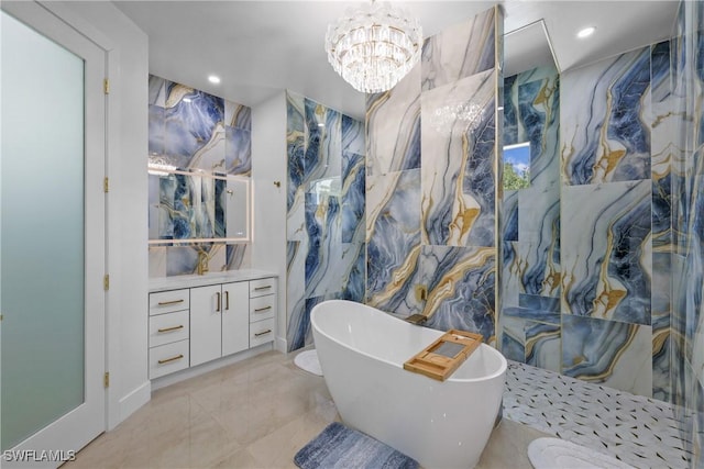 192 Herron Rd, North Fort Myers, FL 33903 - full bathroom featuring a soaking tub, vanity, marble tiled flooring, a chandelier, and recessed lighting