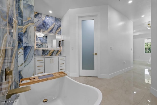 192 Herron Rd, North Fort Myers, FL 33903 - bathroom with a soaking tub, recessed lighting, vanity, and marble finish floors