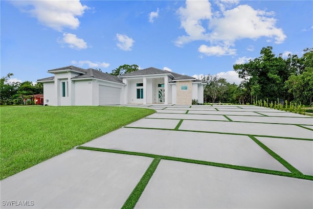 192 Herron Rd, North Fort Myers, FL 33903 - prairie-style home with a front yard, a garage, and stucco siding